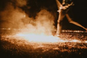 a person standing in front of a fire