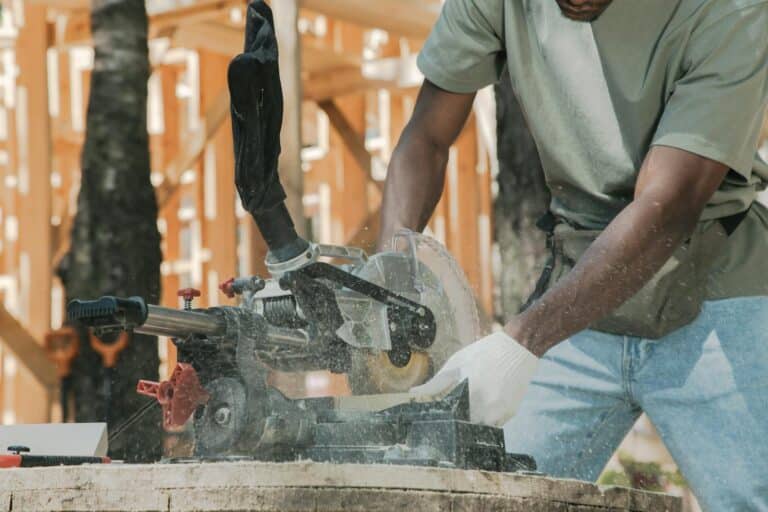 Action shot of a carpenter using a circular saw outdoors, demonstrating precise craftsmanship.