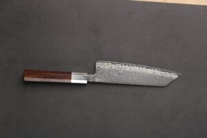 a knife on a cutting board with a wooden handle