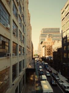 A city street filled with lots of traffic next to tall buildings