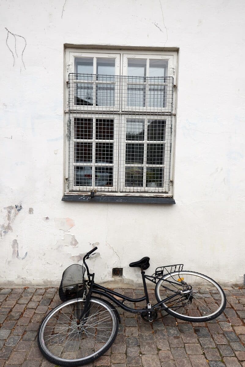 A bicycle parked in front of a white building