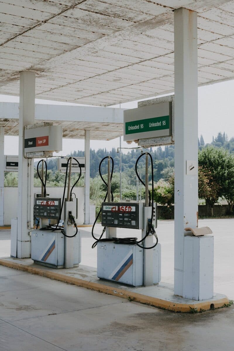 Old gas pumps sit at an abandoned station.