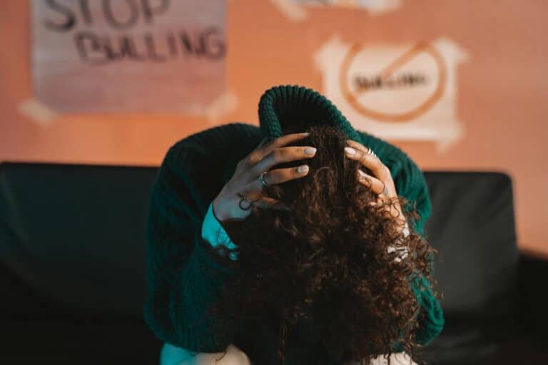 A person in distress, highlighting bullying awareness and mental health issues with a focus on anti-bullying.