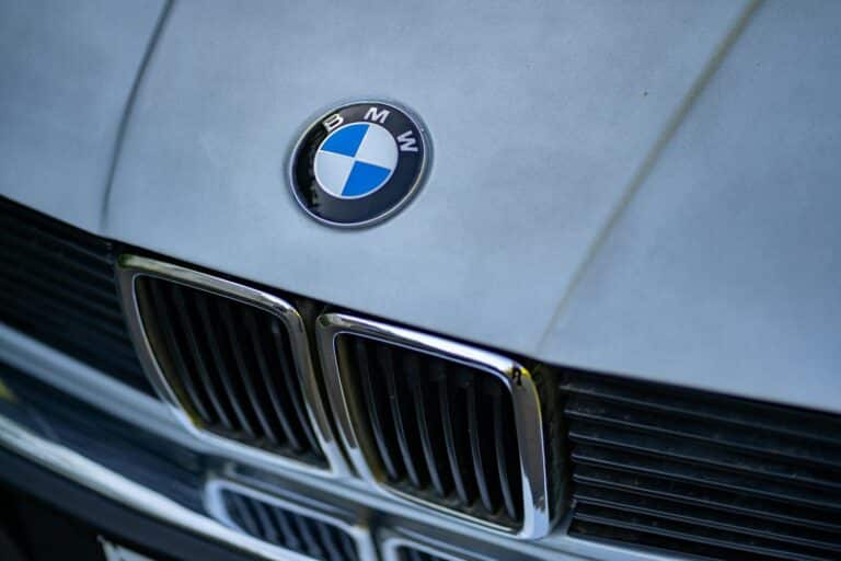 Detailed shot of BMW car emblem focusing on its iconic grille and logo.