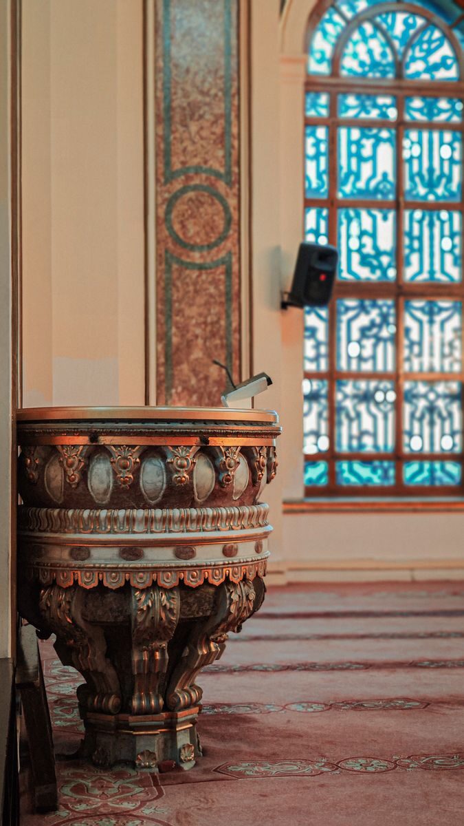 Intricate interior view of Dolmabahce Mosque showcasing ornate decorations and stained glass.