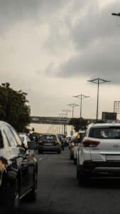 a street filled with lots of traffic under a cloudy sky