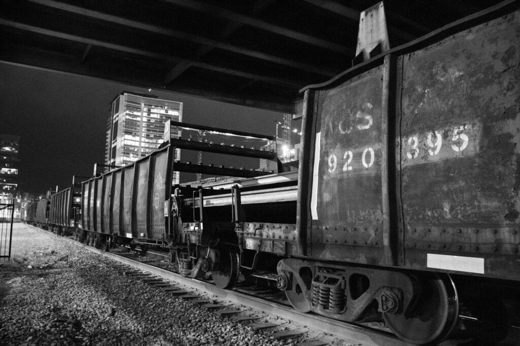 a black and white photo of a train on the tracks