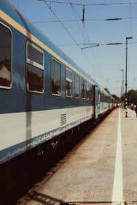 a blue and white train traveling down train tracks