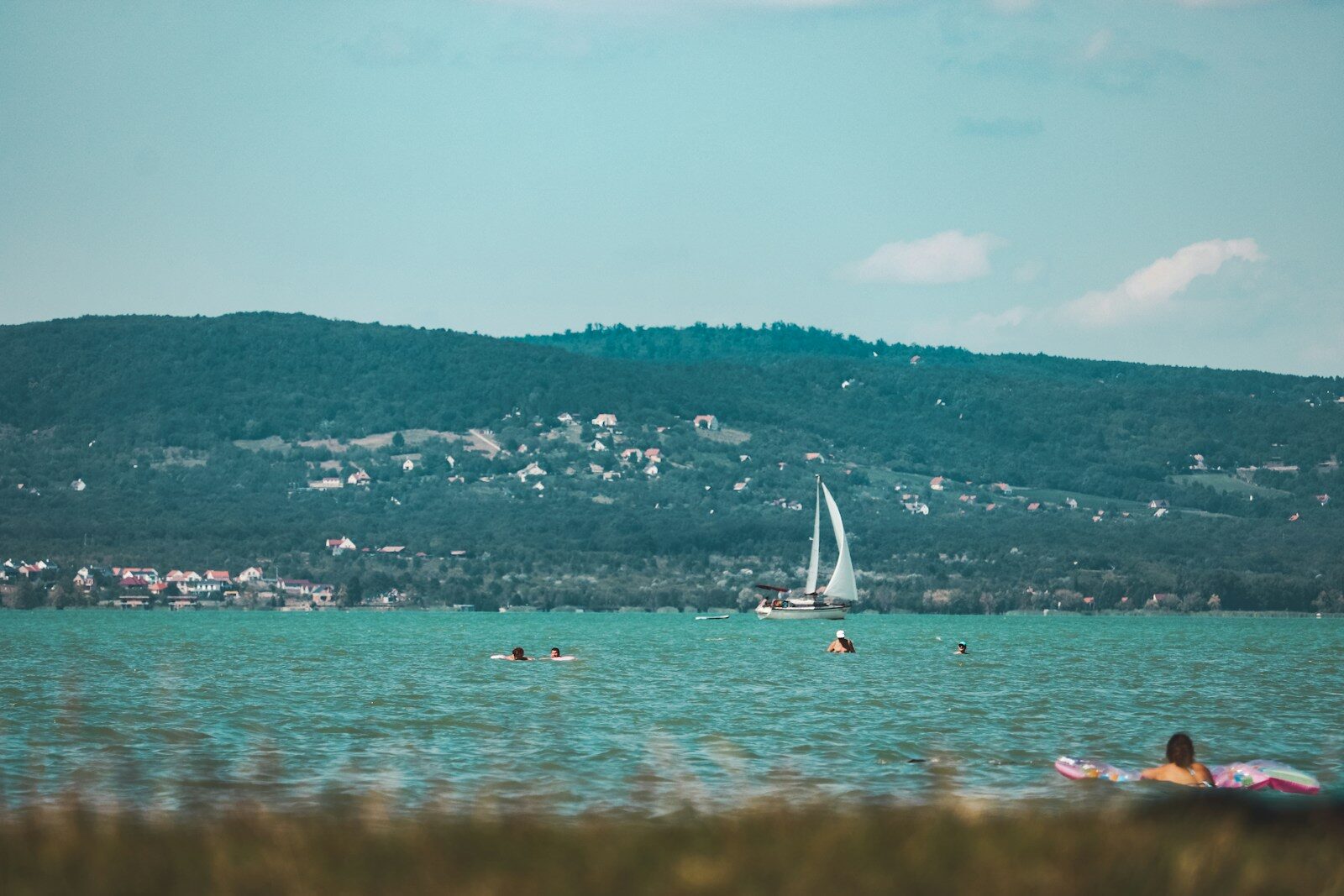 white sail boat on sea during daytime