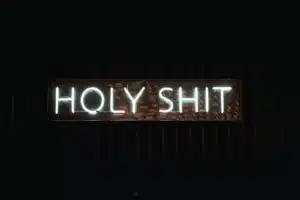 a neon sign that reads holy shit