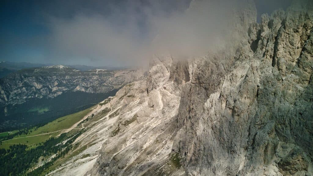 a view of a mountain with a cloud in the sky