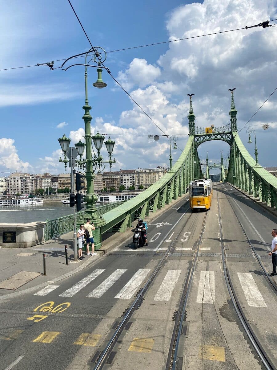 a yellow and white train traveling over a bridge