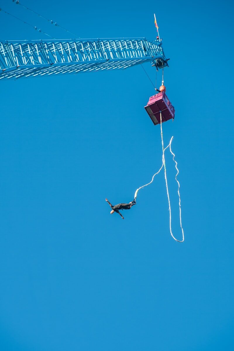 A person bungee jumping from a tall structure