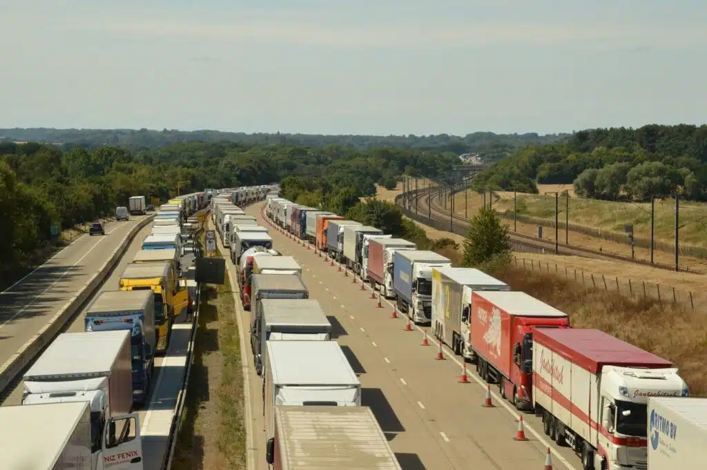 Aerial view of trucks in a traffic jam on a highway in England, showcasing road congestion.
