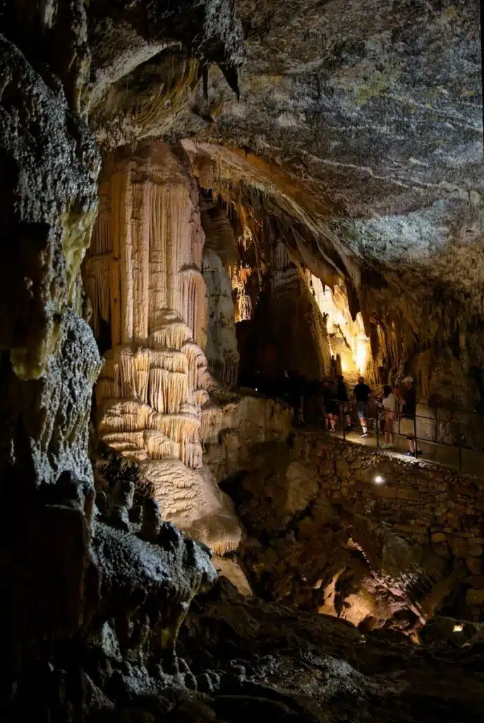 a group of people standing inside of a cave