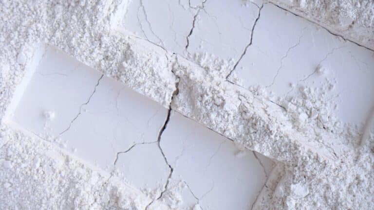 a white brick wall with a crack in it