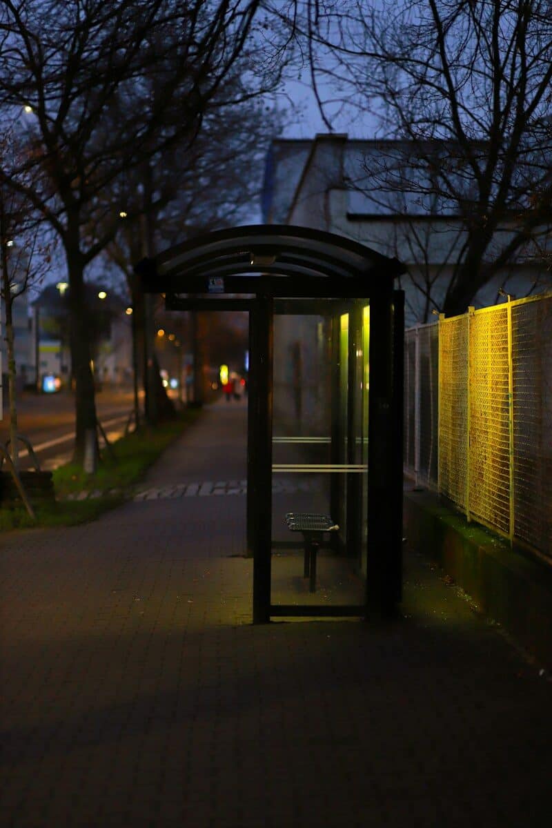 a bus stop sitting on the side of a road